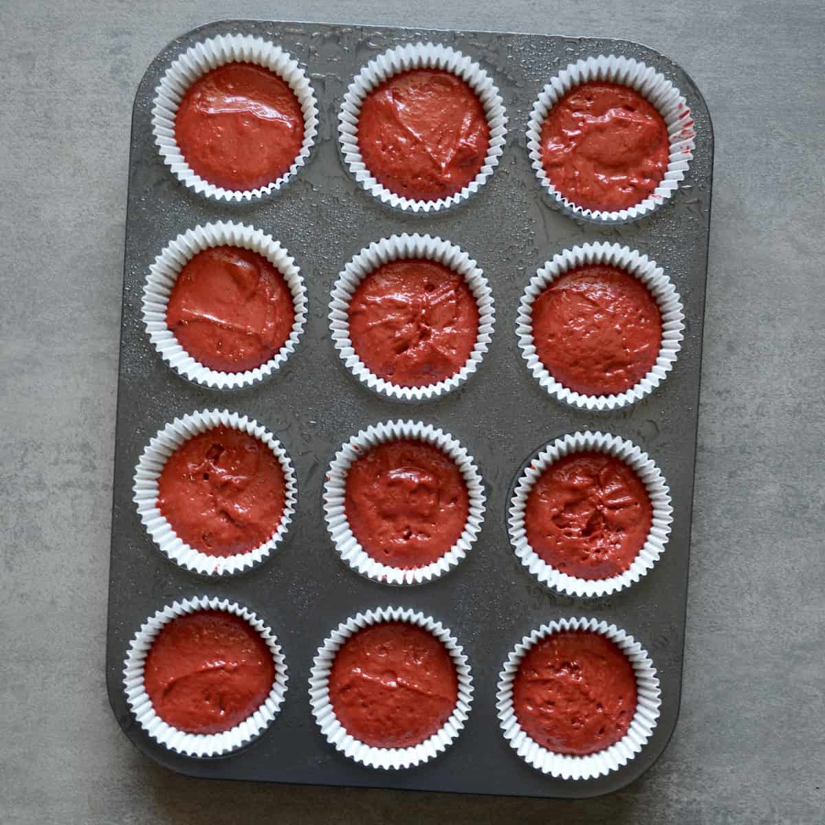 Red velvet cupcakes scooped in a pan