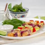 Salmon Skewers served with lemons and greens