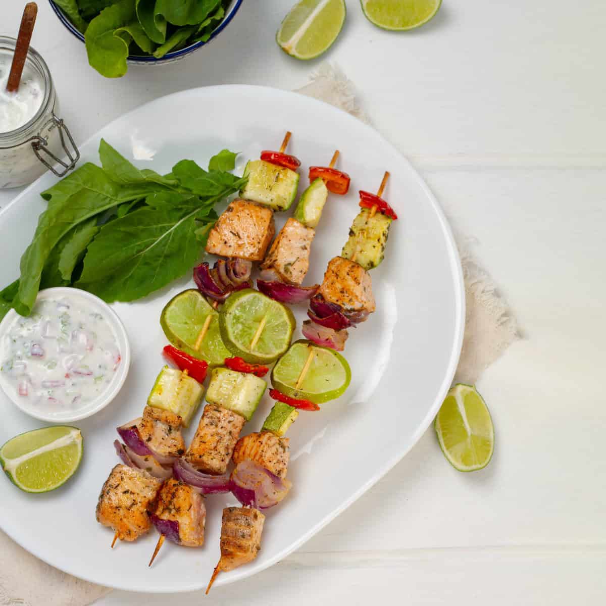 Salmon Skewers served with lemons and greens