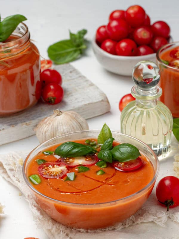Light and refreshing gazpacho in a bowl topped with fresh garnishes.