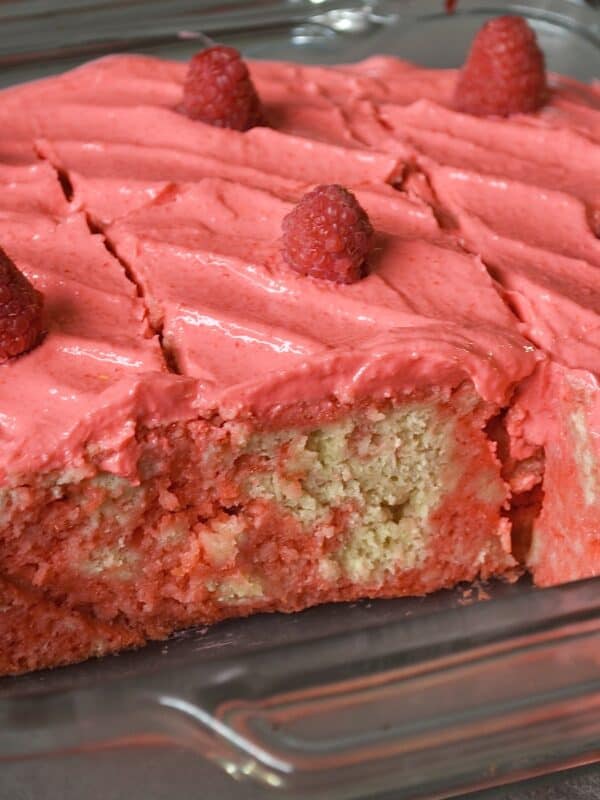 Sliced raspberry cake with fresh raspberries