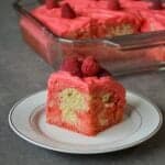 Plated raspberry poke cake slice