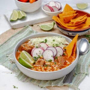 Light posole soup with fresh garnishes in a large bowl.