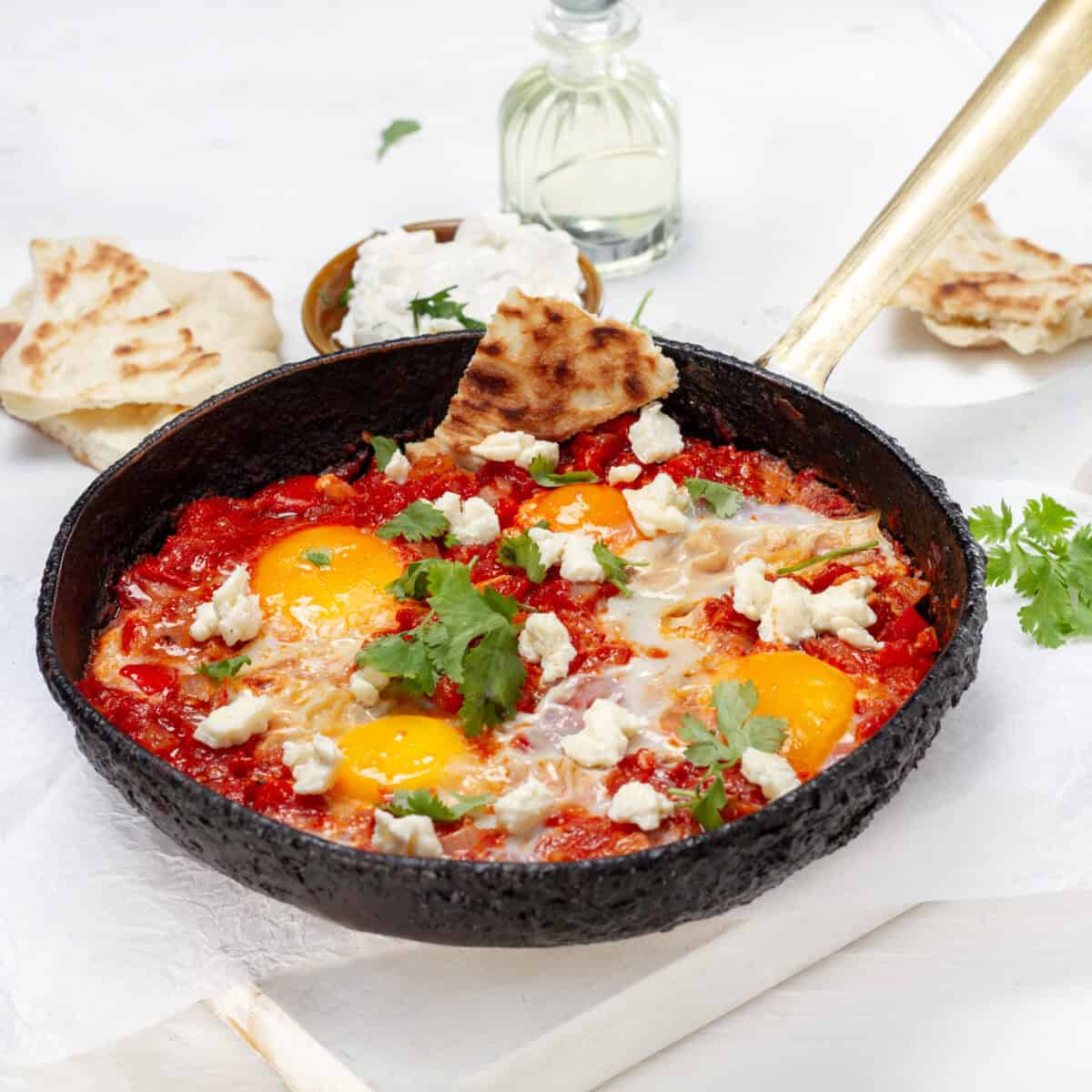 skillet of zero point shakshuka with poached eggs in spiced tomato sauce