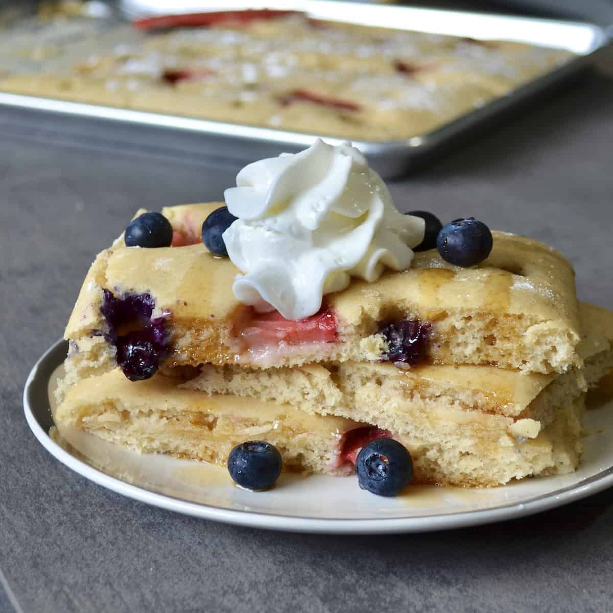 Stack of sheet pan pancakes with berries