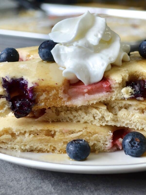 Close-up of stacked pancakes with whipped cream