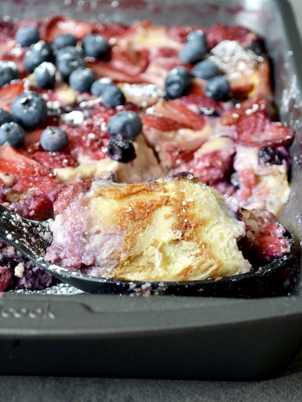 Scoop of breakfast casserole with berries