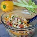 Mixing chickpea salad ingredients