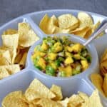 Mango salsa in a chip and dip platter