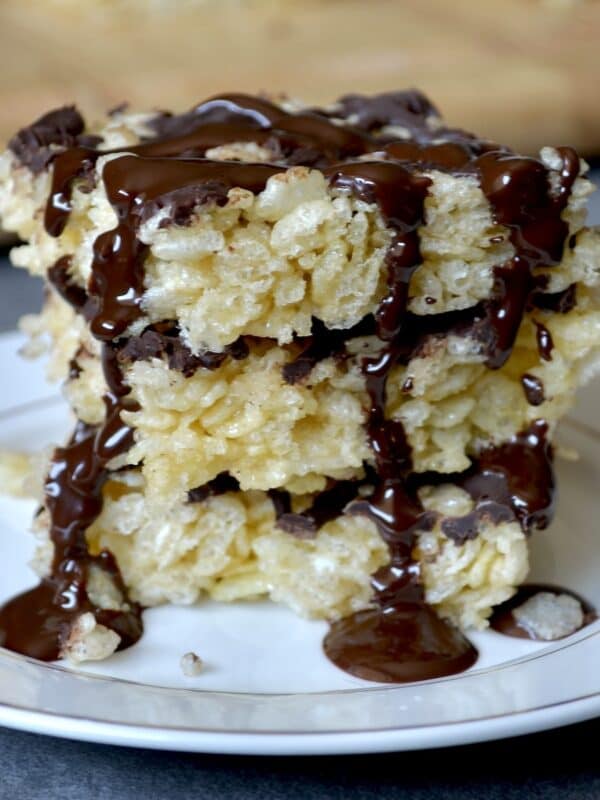 Stack of rice krispie treats with melted chocolate