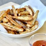French fries in a bowl with ketchup