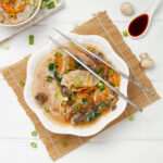 Light yet hearty Chinese dumpling soup in a bowl with chopsticks.