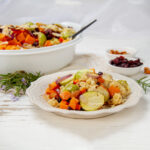 Harvest Chicken Casserole served on a plate with the baking dish to the side.