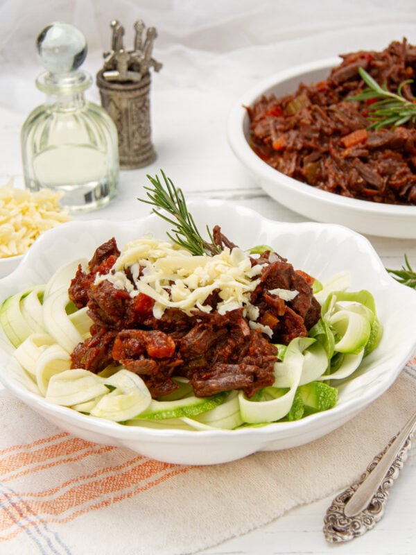Instant Pot Beef Ragu served over zucchini noodles and topped with freshly grated cheese.
