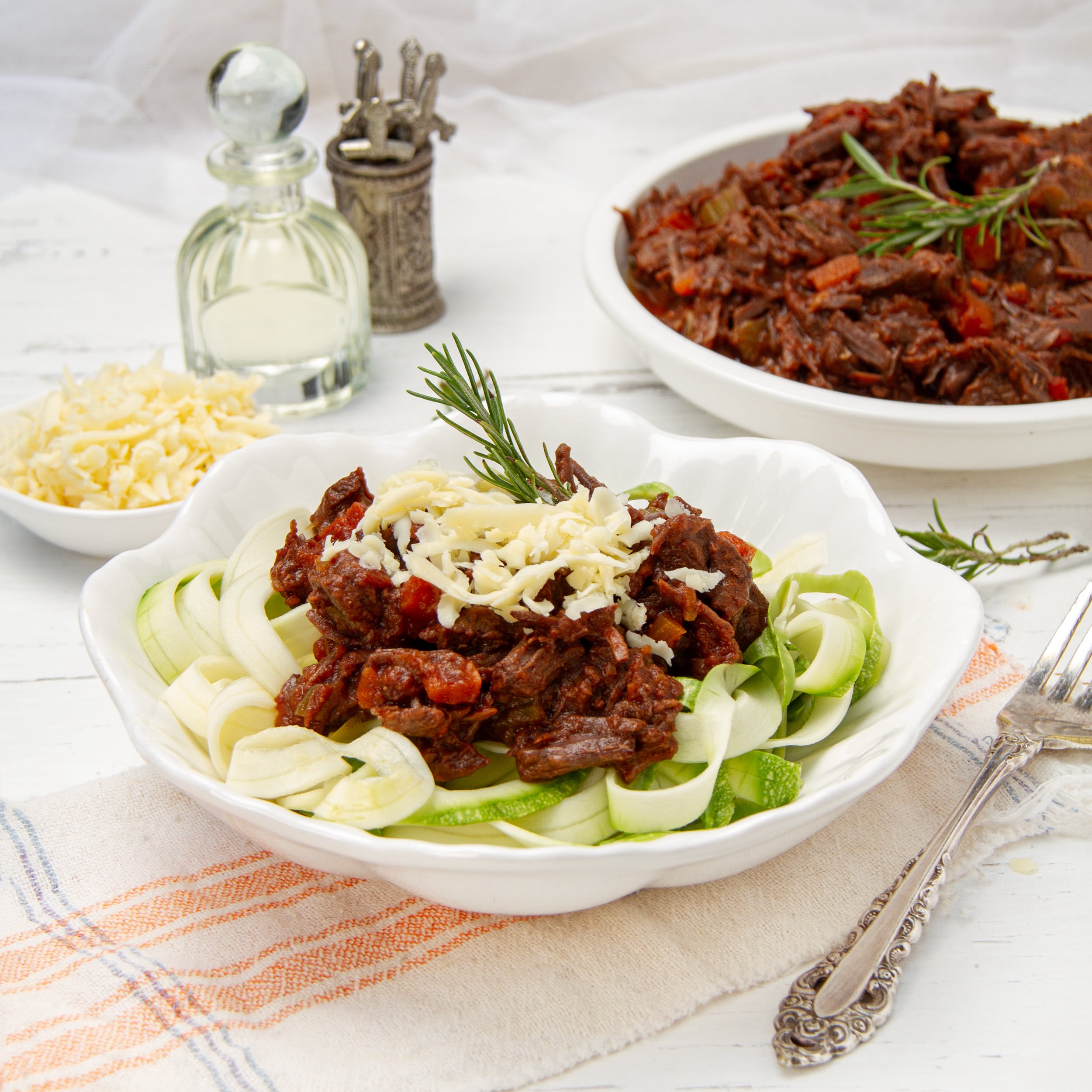 Instant Pot Beef Ragu served over zucchini noodles and topped with freshly grated cheese.