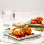 TikTok viral Egg Boils in tomato sauce on a small plate.