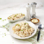 Creamy Angel Chicken Pasta on a plate with salt and pepper shakers on the side.