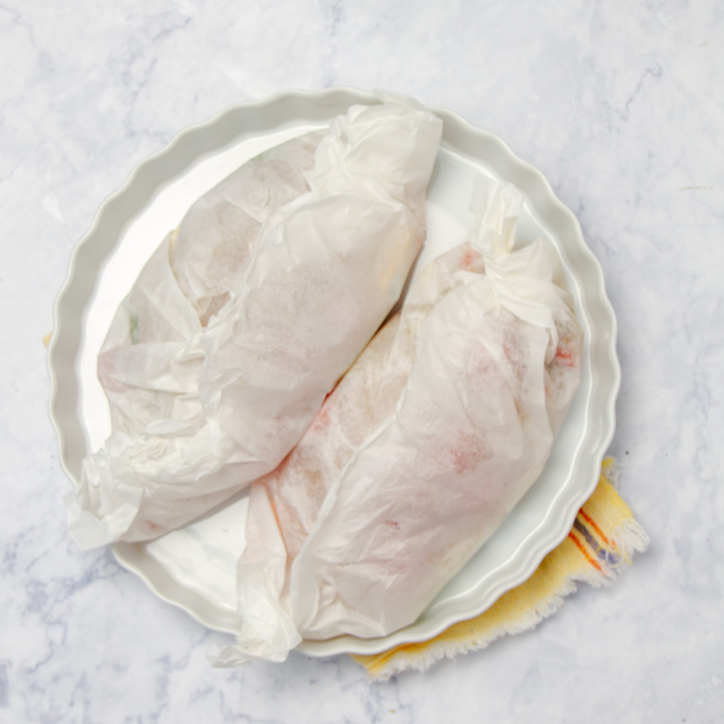Fish and vegetables wrapped up in the parchment paper.