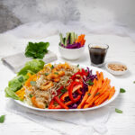 Crunchy and vibrant Vietnamese Spring Roll in a Bowl with extra sauce on the side.
