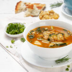 Light yet hearty Spring Minestrone soup with fresh herbs on the side.