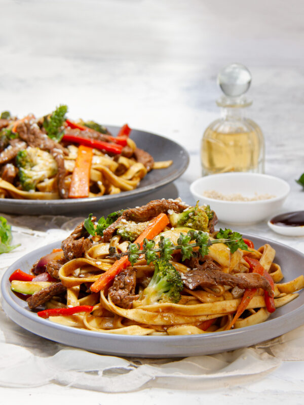 Vibrant flavor-packed Beef Noodles with veggies and tender beef on a plate.