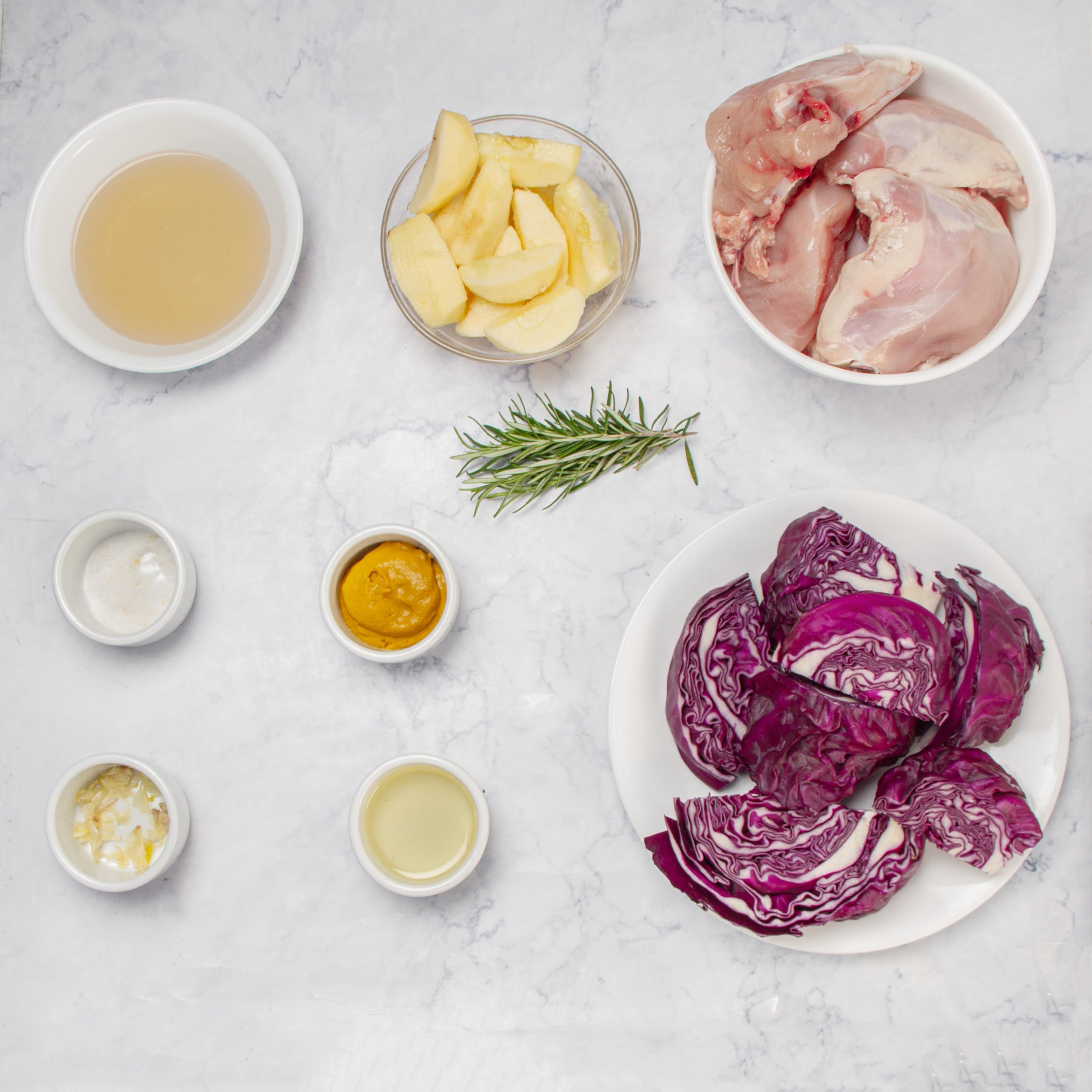 Apple Cider Baked Chicken in separate dishes on a countertop. 
