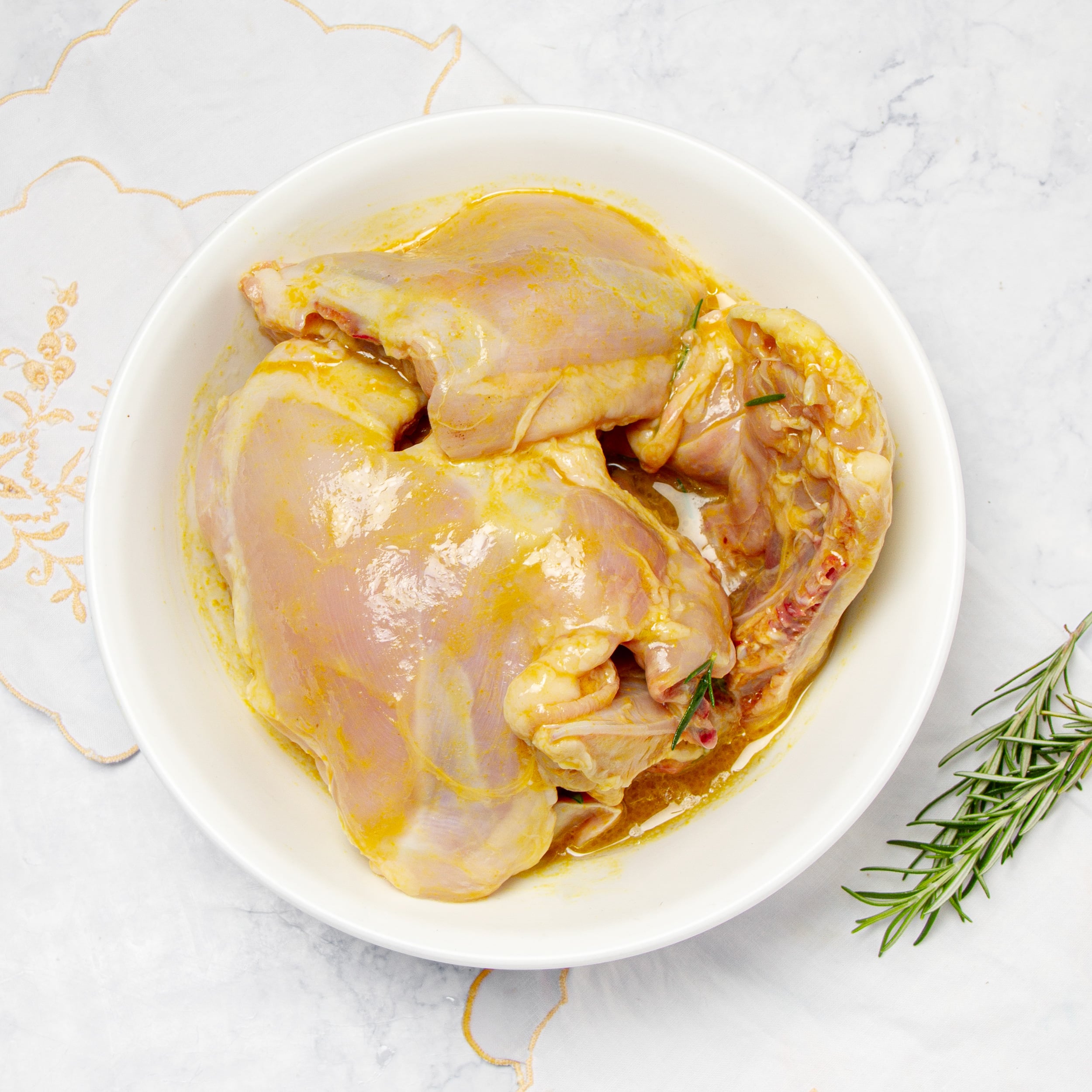 Raw chicken marinating in a bowl. 