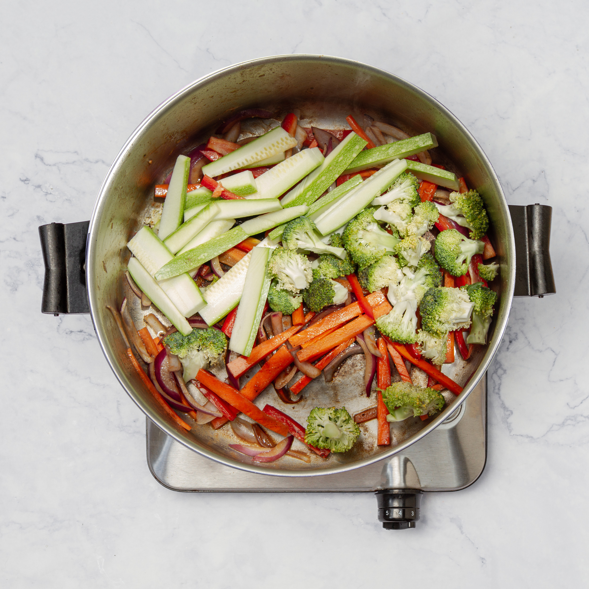 Veggies pan-frying in the same pan, with the beef removed.