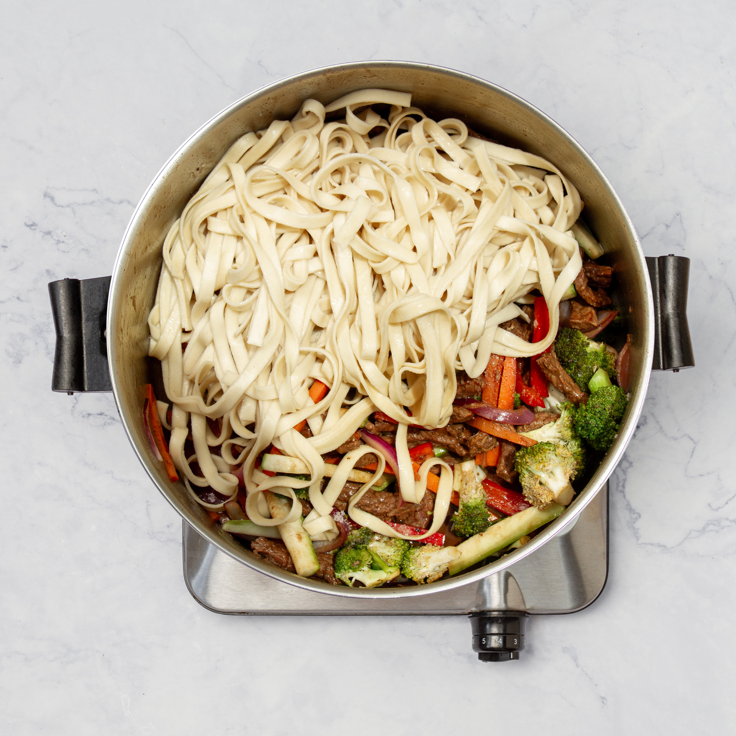 Noodles added to the beef and veggie stir-fry.