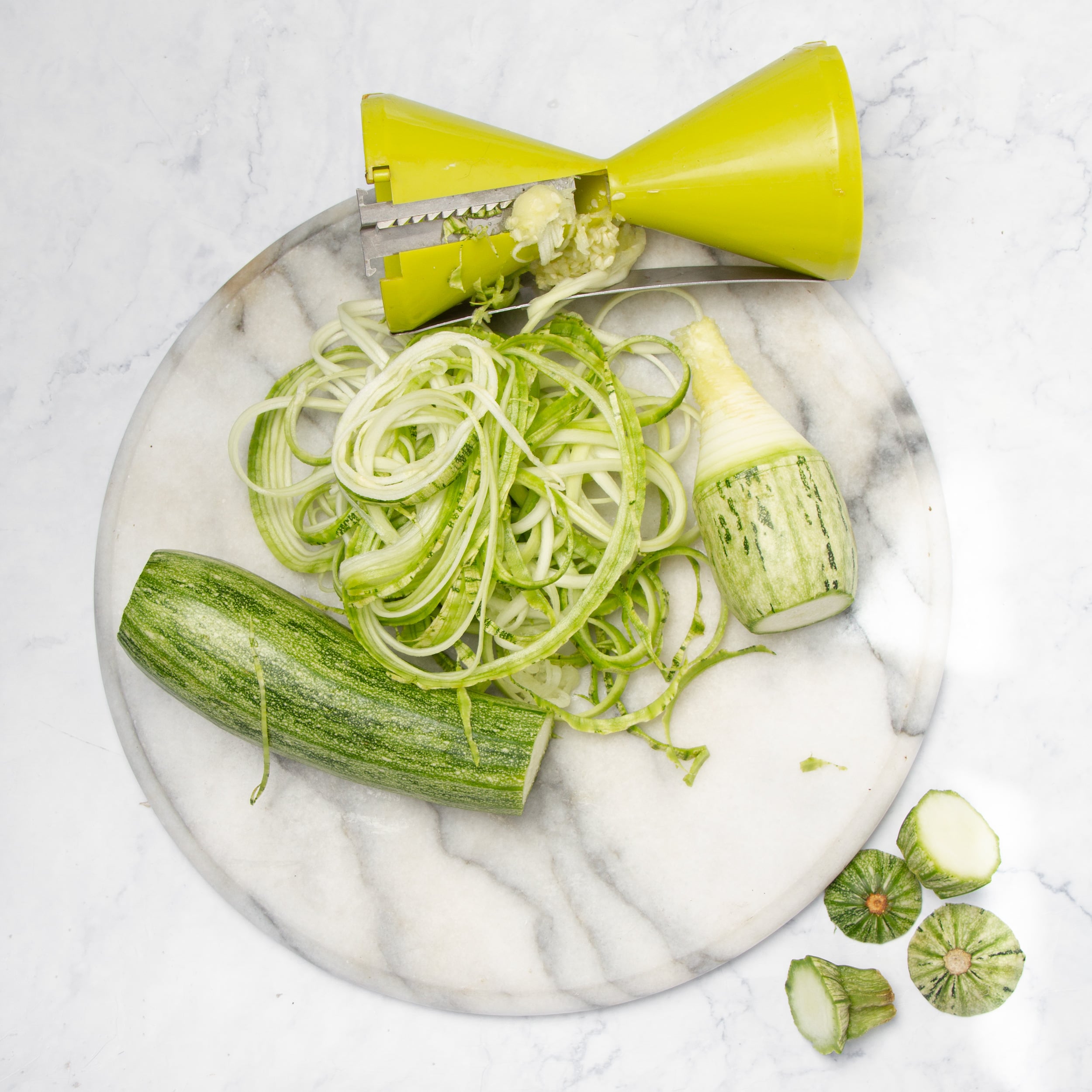 Spiralizing the zucchini into noodles.