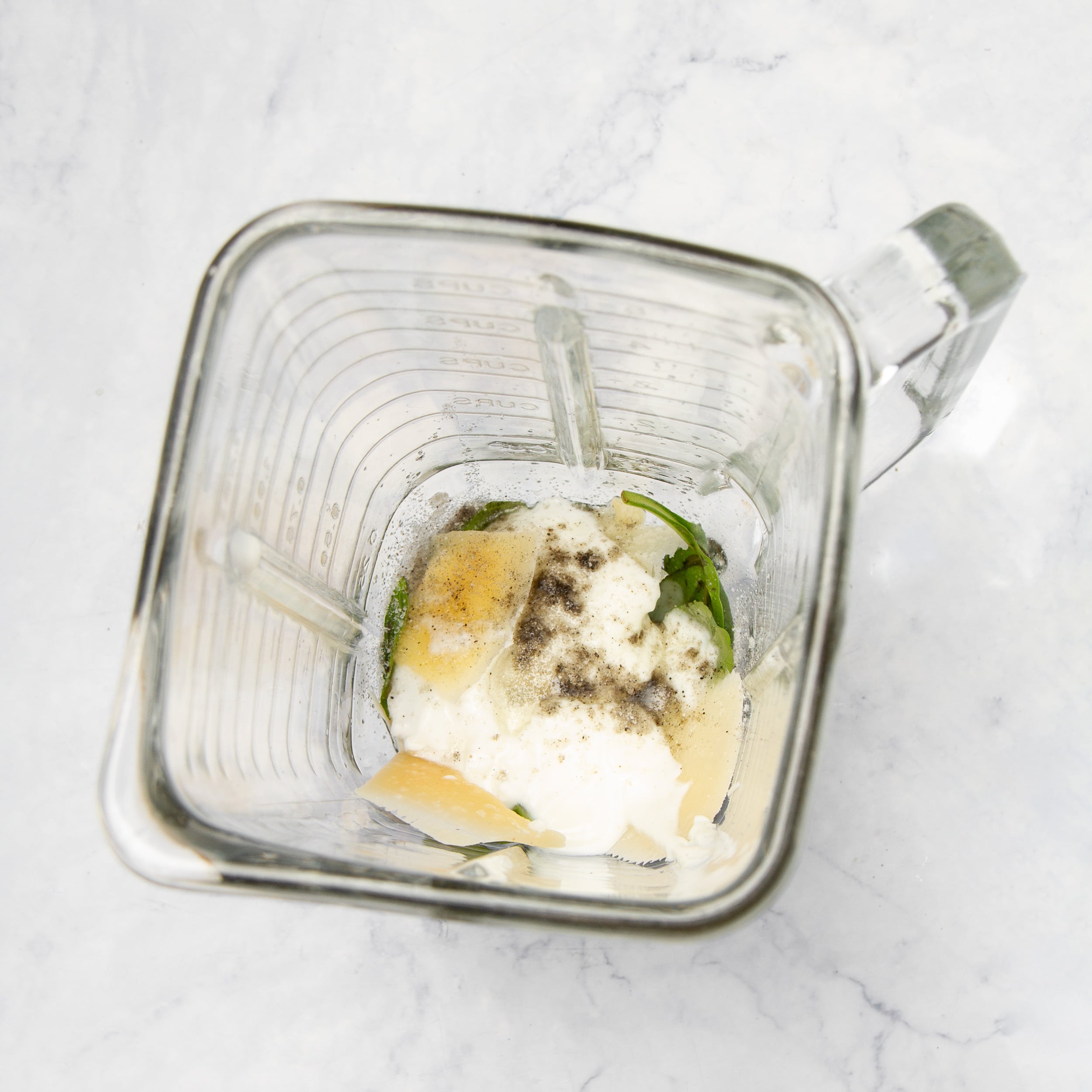 Pesto ingredients in a blender.