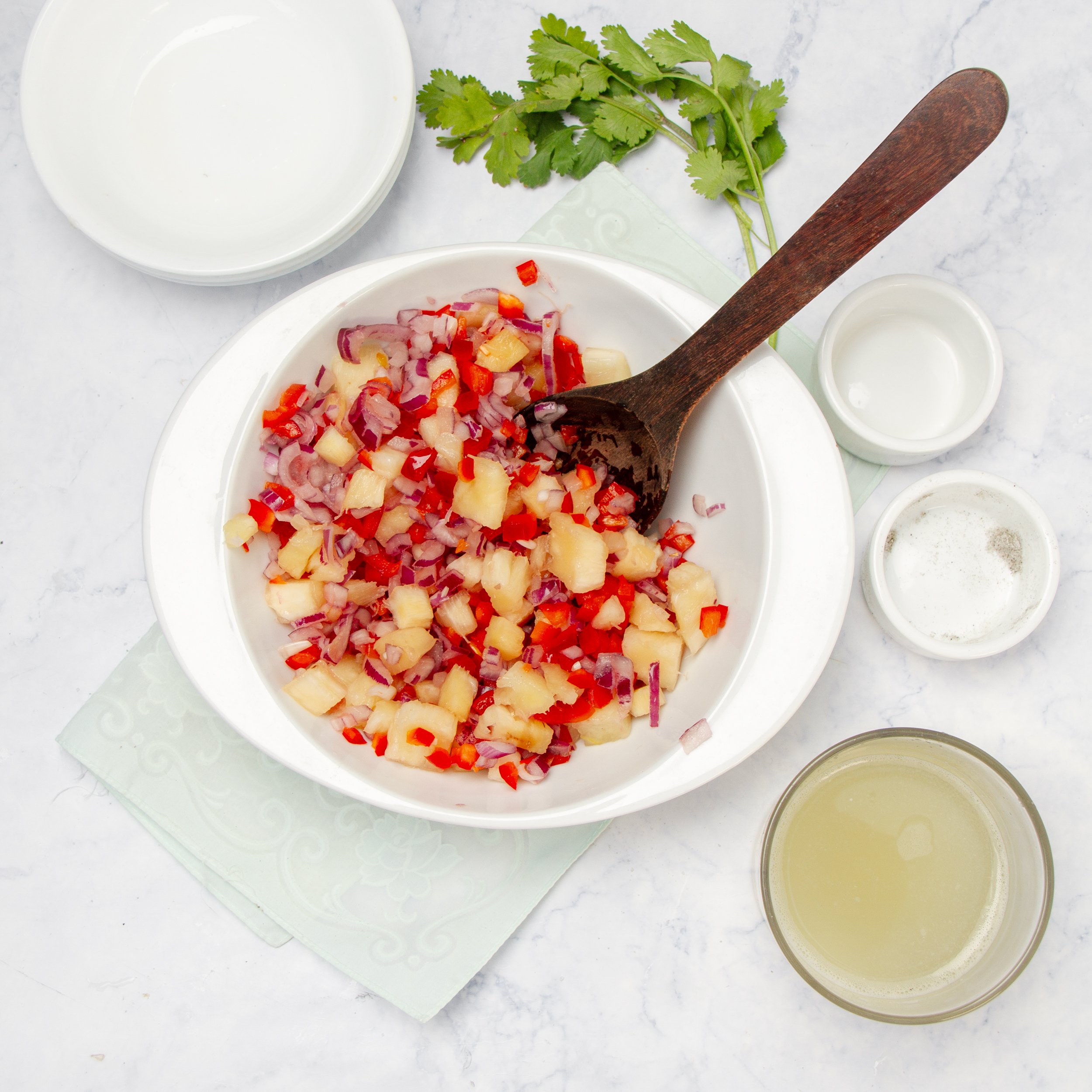 Pineapple salsa ingredients mixed in a small bowl.