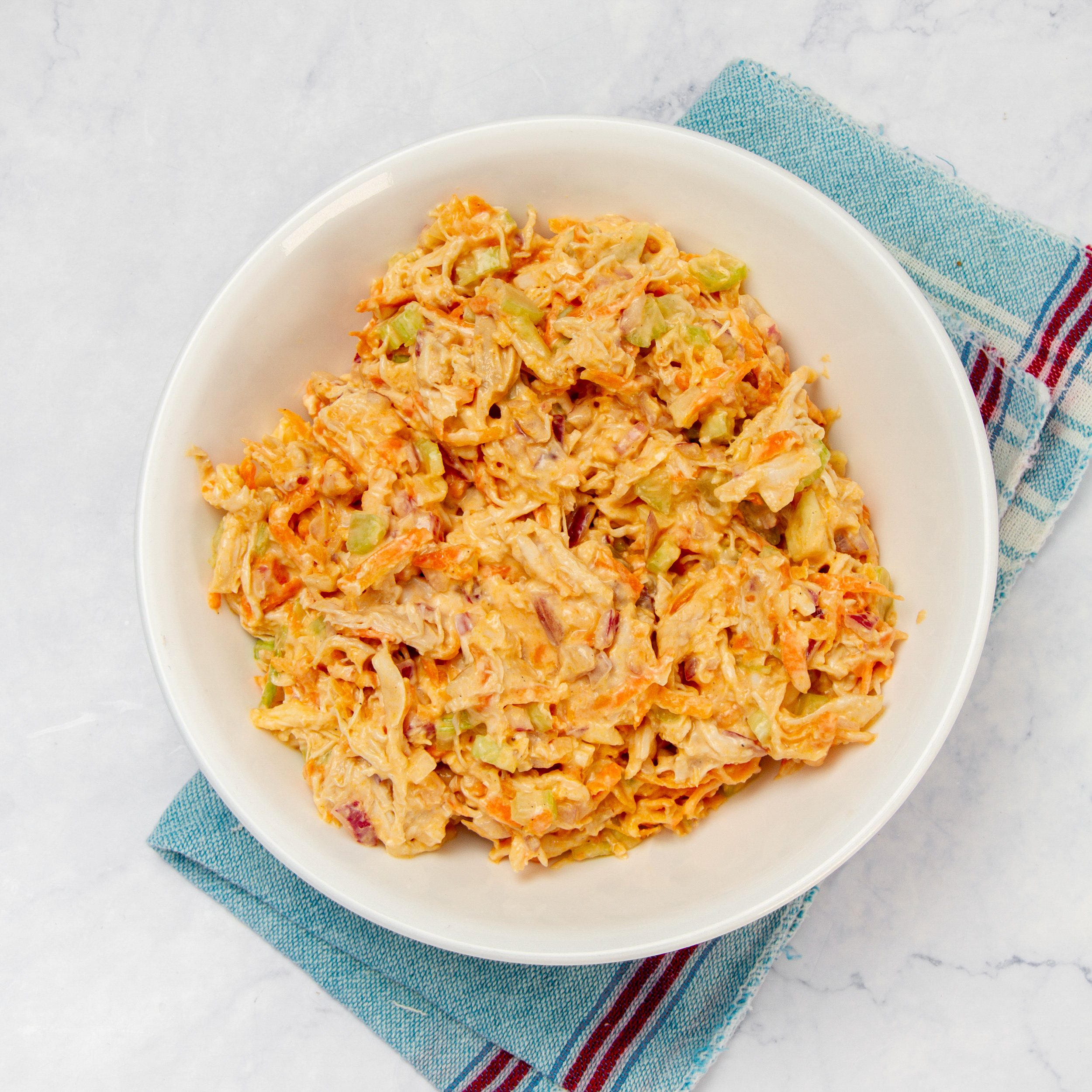 Mix well to combine the chopped salad ingredients with the buffalo sauce dressing.