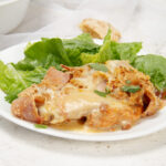 Creamy, meaty, and full of flavor±cordon bleu casserole served on a plate with a simple side salad. A perfect meal!