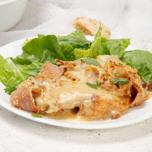 Creamy, meaty, and full of flavor±cordon bleu casserole served on a plate with a simple side salad. A perfect meal!