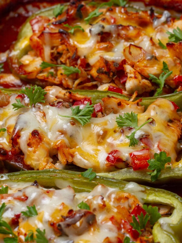 Spicy, loaded, and delicious Enchilada Stuffed Poblano Peppers, topped with melty cheese and fresh herbs.
