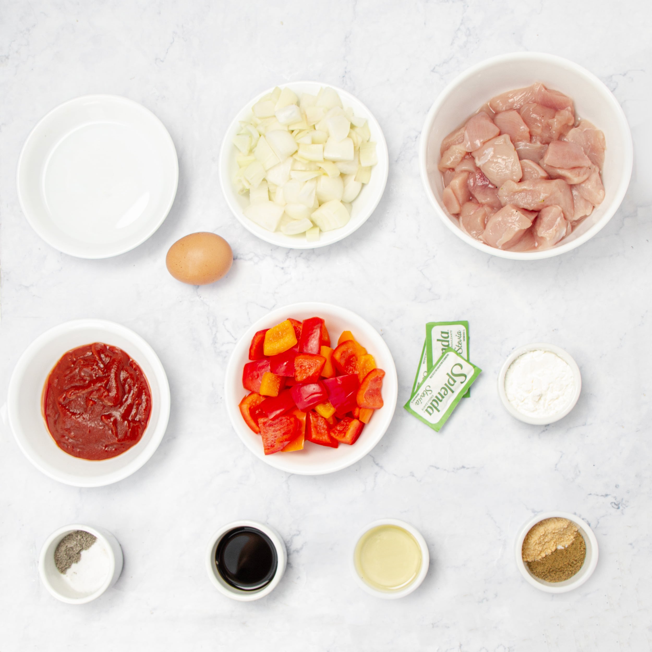 Accessible and affordable ingredients for healthy sweet and sour chicken in separate dishes.