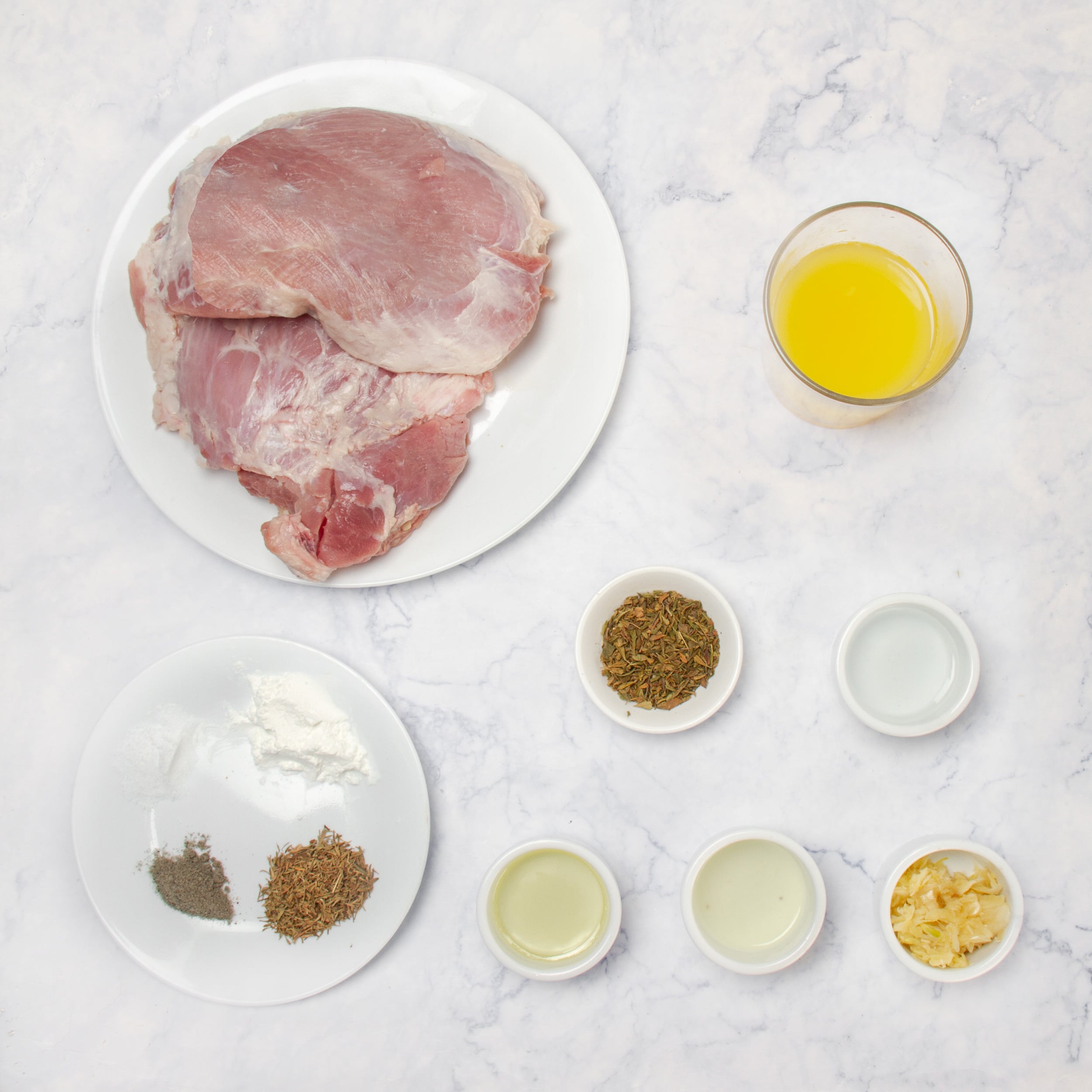 Bold and zesty Mojo Cuban Pork ingredients in separate dishes. 