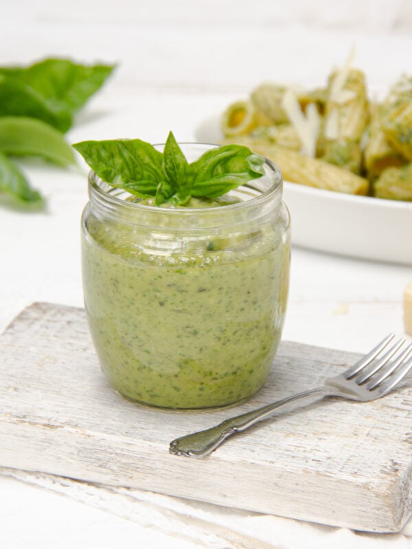 Quick, easy, and flavorful-fresh! Healthy Pesto in a jar with fresh herbs on top.