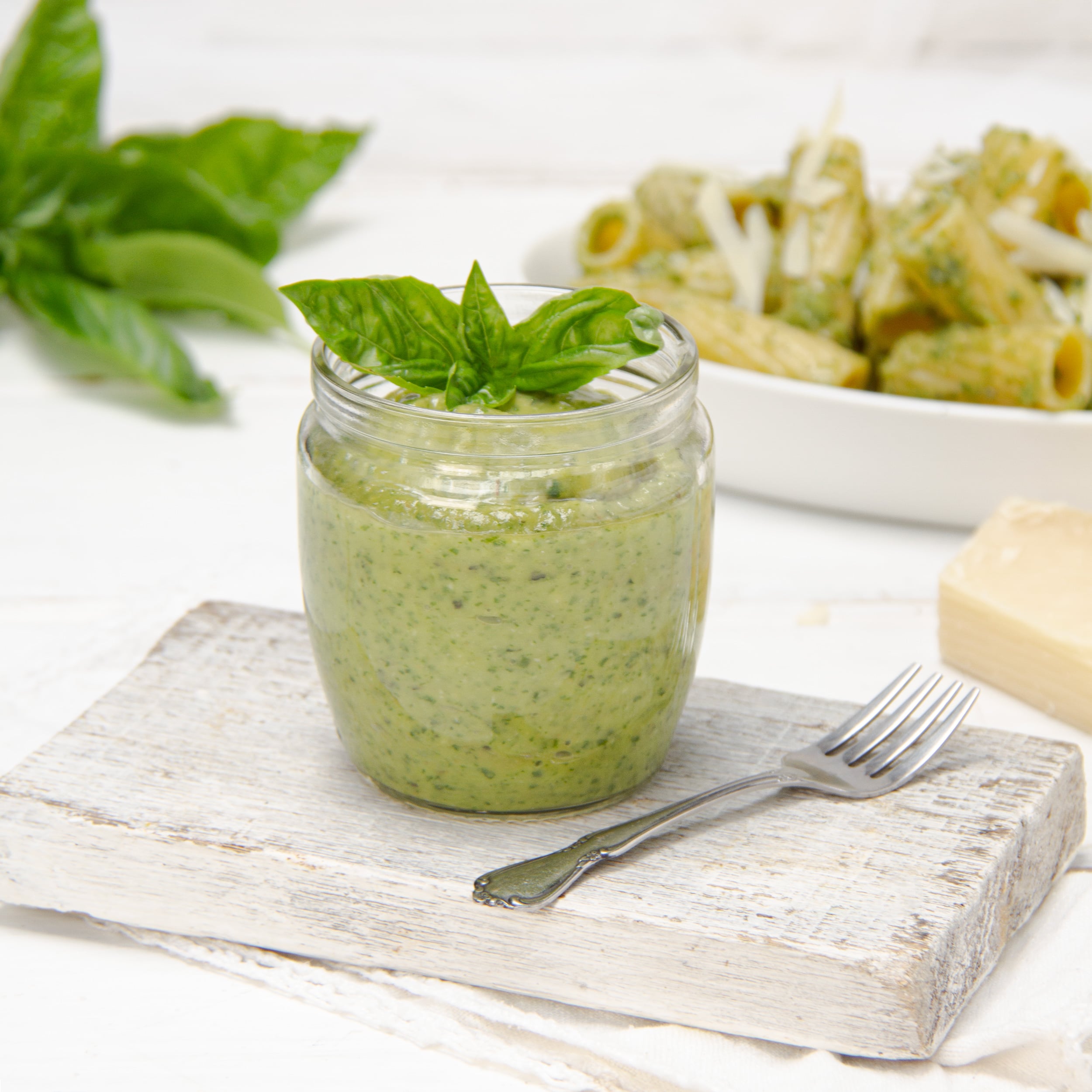 Quick, easy, and flavorful-fresh! Healthy Pesto in a jar with fresh herbs on top.