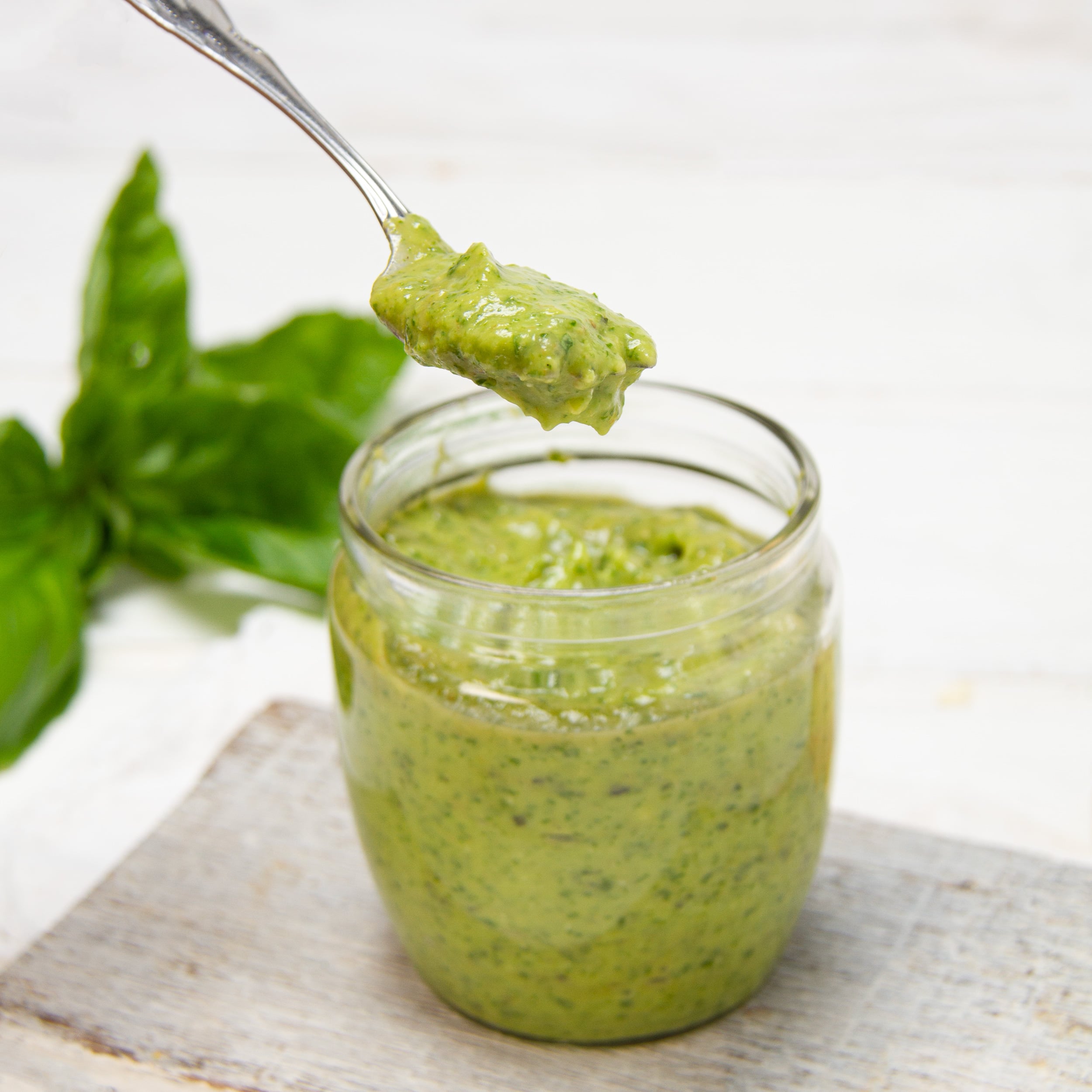 Creamy, fresh and healthy pesto in a jar, ready for serving.
