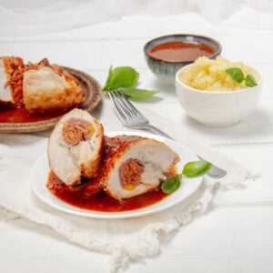 Light, juicy, and stuffed with goodness—saucy Chicken Rollatini on a plate.