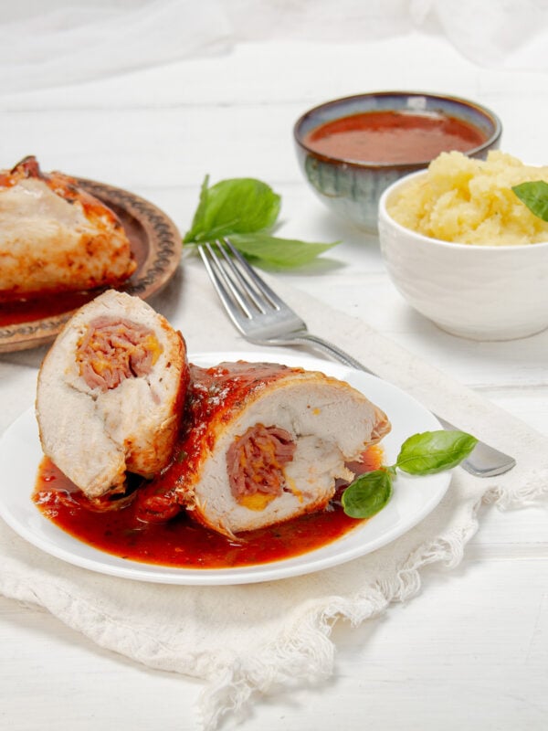 Light, juicy, and stuffed with goodness—saucy Chicken Rollatini on a plate.