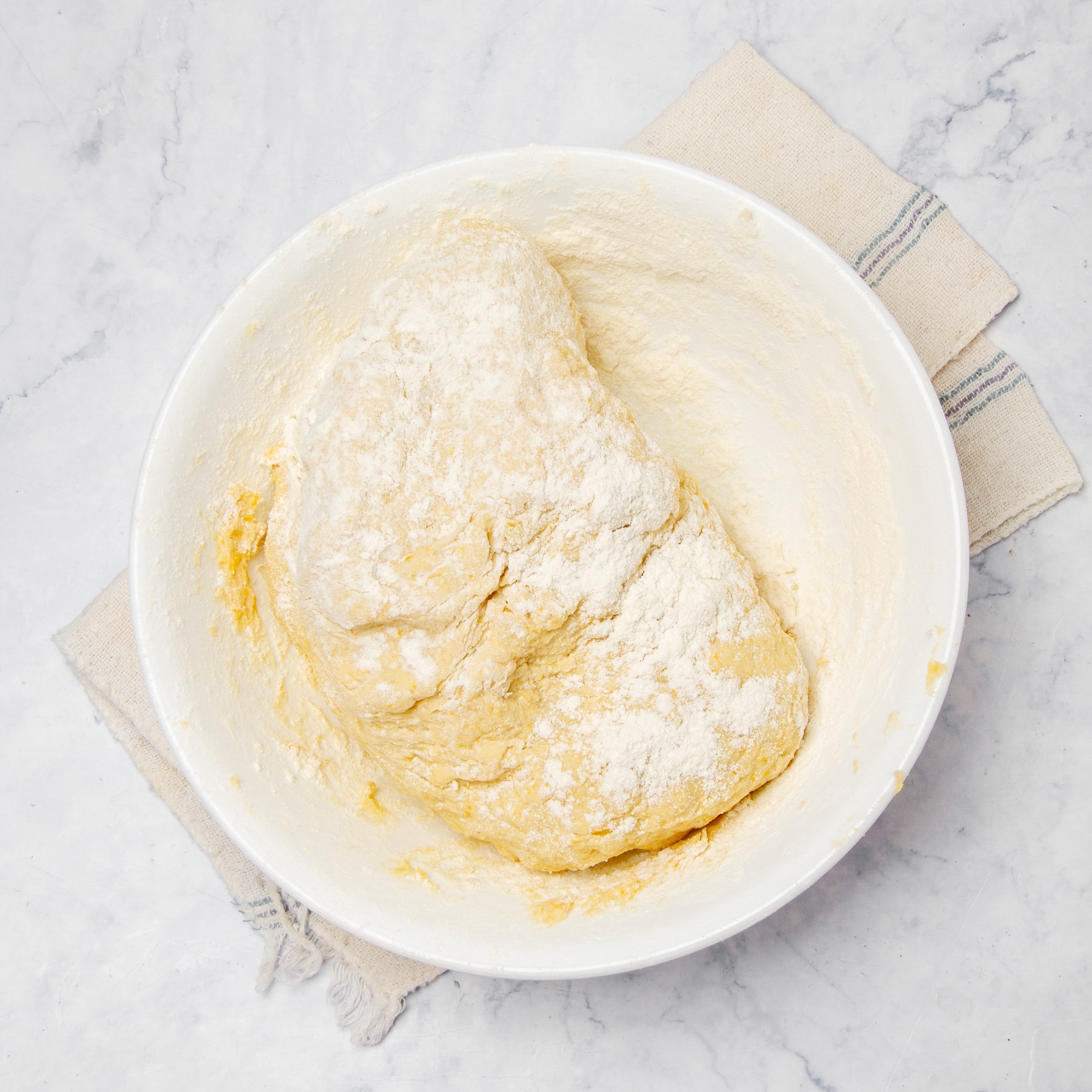 Pumpkin gnocchi dough mixed and shaped in a shallow dish.