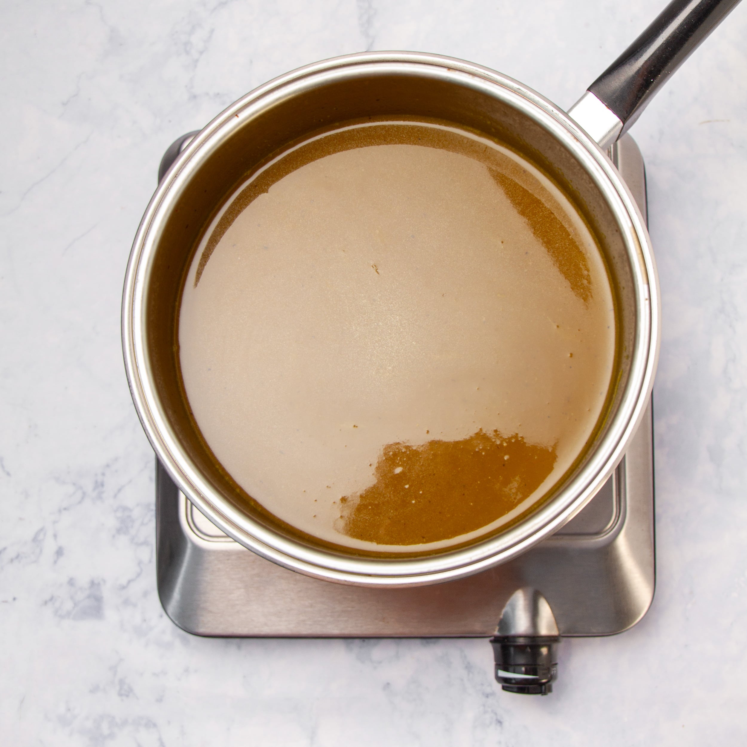 Mojo sauce cooking in a small saucepan. 
