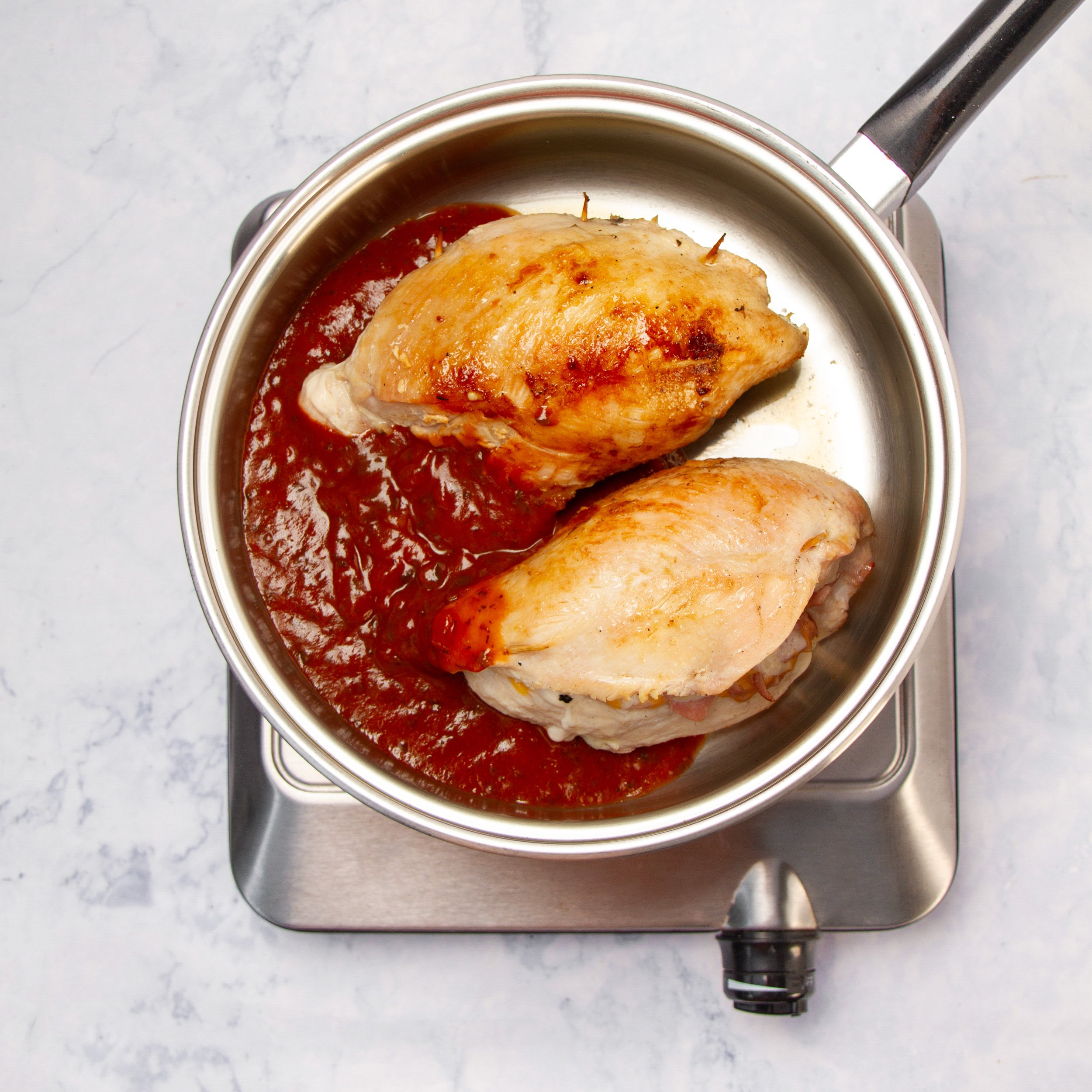 Sauce added to the pan with cooked chicken breasts.