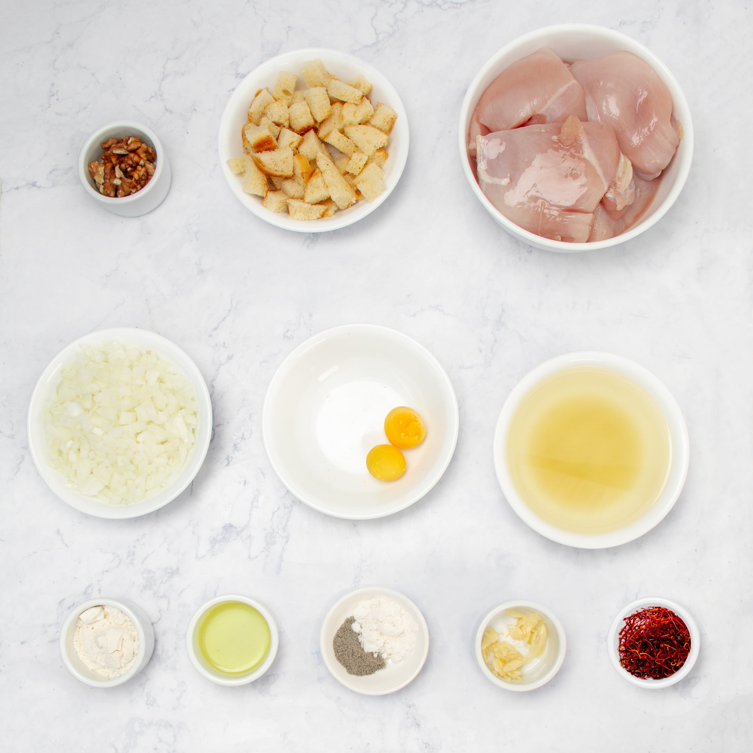 Ingredients for Chicken Pepitoria in separate dishes. 