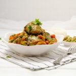 Seco de Pollo, a vibrant Ecuadorian-style chicken stew, piled high in a bowl.