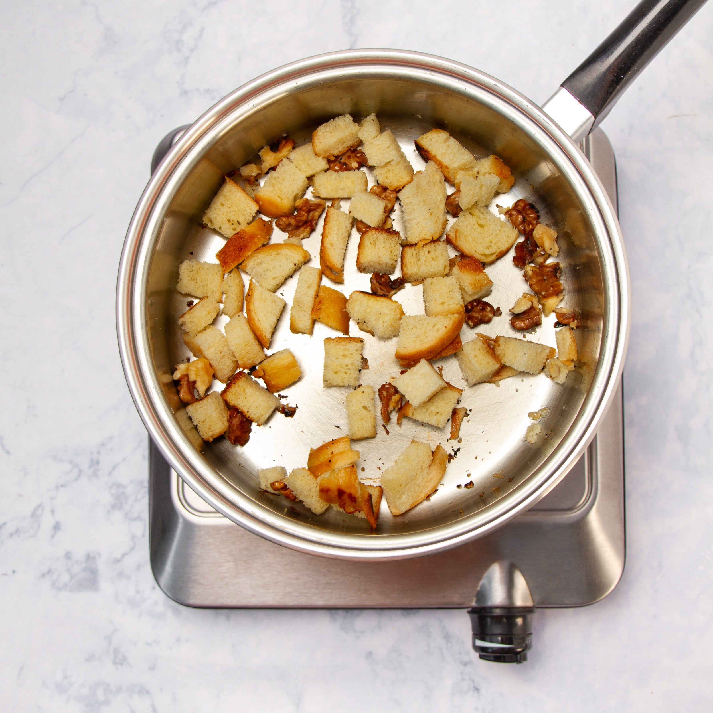 Croutons toasting in a hot pan. 