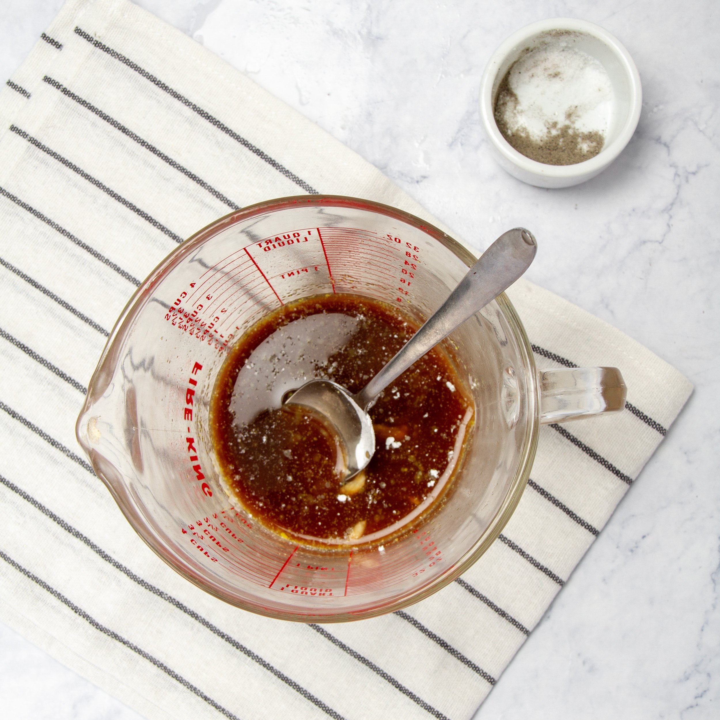 Sauce ingredients mixed in a small measuring cup. 